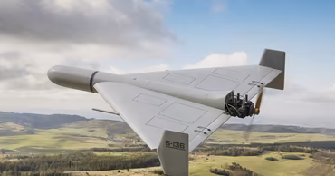 A Geran-2 kamikaze drone flying over a rural landscape.