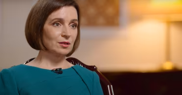 A portrait of Moldovan President Maia Sandu wearing a green dress.