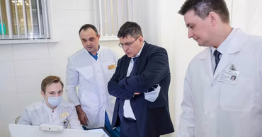 Medical staff and an official working in an office at the Timofei Mosneaga Republican Clinical Hospital.