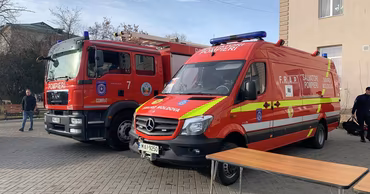 Moldovan emergency services fire truck and SMURD ambulance parked on a street.
