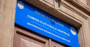 The sign of the Central Electoral Commission of Moldova on a building facade.