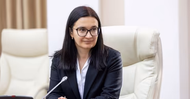 Prosecutor Cristina Gema sitting at a table during a meeting.