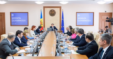 Dorin Recean chairing a government meeting in Chisinau with various officials present.