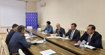 A group of officials sitting at a conference table in an ANSP office.