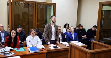 A group of people sitting in a courtroom during a legal proceeding.