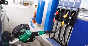 A car being refueled at a gas station pump.
