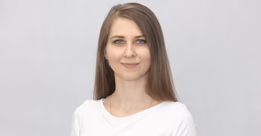 A portrait of Tatiana Vozian against a neutral background.