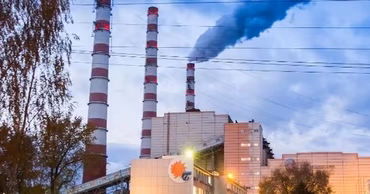 The Cuciurgan power plant with smoking chimneys at dusk.