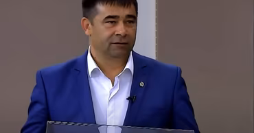 Prosecutor Nicolae Matasaru speaking at a podium.