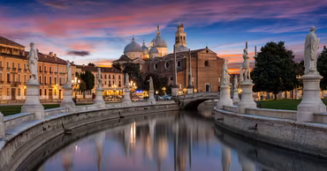A scenic view of Prato della Valle in Padua, Italy, at sunset.