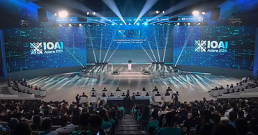 The stage of the International Olympiad in Artificial Intelligence in Astana with participants in the audience.
