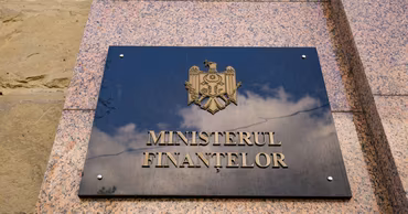 The sign of the Ministry of Finance of the Republic of Moldova on a stone wall.