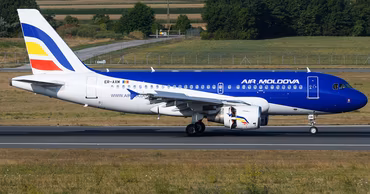 An Air Moldova passenger airplane taxiing on the runway.