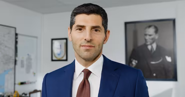 A portrait of a man in a suit, likely an executive from ONUR construction company.