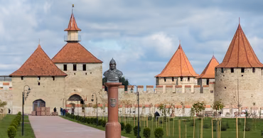 Bender Fortress in Transnistria with a monument in the foreground.