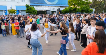 Young people dancing in a public square in Balti during a youth event.
