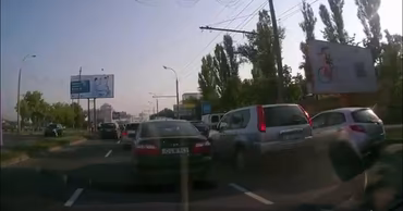 View from a car dashboard showing heavy traffic on a city road in Chisinau.