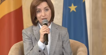 Maia Sandu speaking into a microphone during an official event.