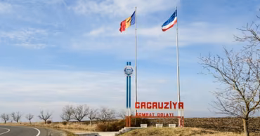 Entrance sign to Gagauzia with Moldovan and Gagauzian flags flying.