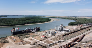 Aerial view of the Giurgiulesti port in Moldova with a cargo ship and industrial infrastructure.