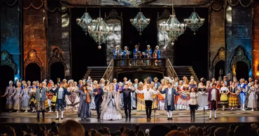 Opera performers taking a bow on stage at the Maria Biesu National Opera and Ballet Theater in Chisinau.