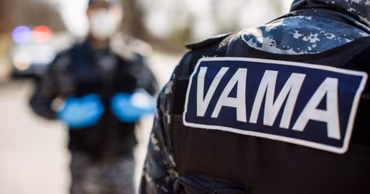 Moldovan customs officers in uniform with VAMA insignia on their vests.