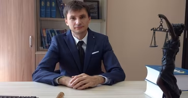 Judge Ion Bulhac sitting at his desk in a courtroom office.