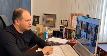 Ion Ceban sitting at his desk in his office during a video conference.