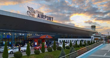 Exterior view of Chisinau International Airport building at sunset.