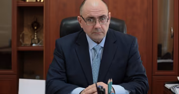 Alexandr Petkov sitting at his office desk.