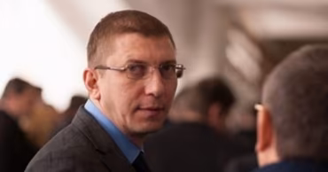 A portrait of Viorel Sokirke in a suit.