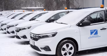 A row of white cars with the logo of the National Road Administration parked in the snow.