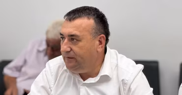 Valentin Gaidarji sitting in a room, wearing a white shirt.