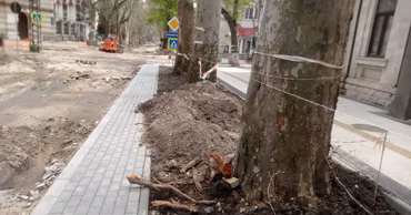 Construction site on 31 August 1989 street in Chisinau with temporary safety tape and pavement works.