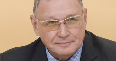 Portrait of Oleg Ozerov wearing a suit and glasses.