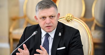 Slovak Prime Minister Robert Fico sitting at a table during a meeting.