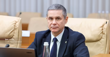 Anatolie Nosatii, Minister of Defense of Moldova, sitting at a table.