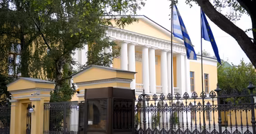 The building of the Greek embassy with Greek and European Union flags.