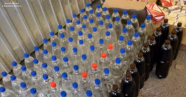 Plastic bottles filled with liquid and cigarette packs seized by Moldovan authorities.
