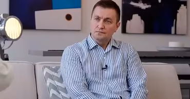 Veaceslav Platon sitting on a sofa during an interview.
