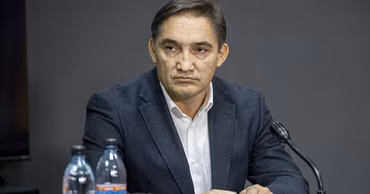 Andrei Dulgheru sitting at a table during a meeting.