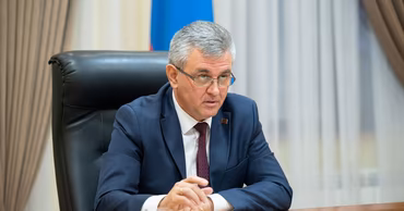 Vadim Krasnoselsky sitting at a desk in an office setting.
