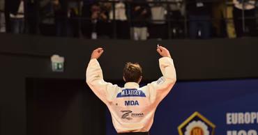 Moldovan judoka Mihail Latisev wearing his competition uniform with his name on the back.