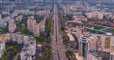 Aerial view of a wide boulevard in Chisinau, Moldova, surrounded by residential apartment buildings.