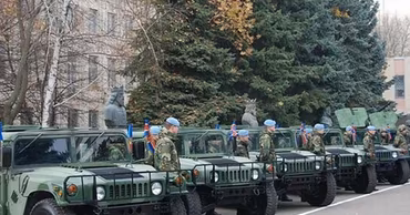 Moldovan soldiers standing next to military Humvees during a training event.