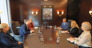Government officials sitting around a conference table during a formal meeting in Moldova.