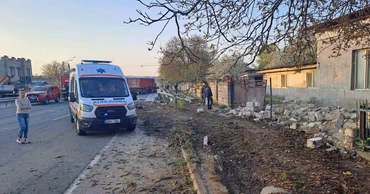 An ambulance and emergency responders at the scene of a road accident in a Moldovan village.