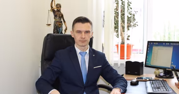 Sergiu Russu sitting at an office desk.