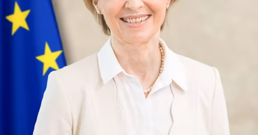 Official portrait of Ursula von der Leyen with the European Union flag in the background.