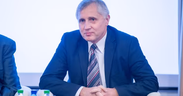 Mircea Eșanu sitting at a conference table.
